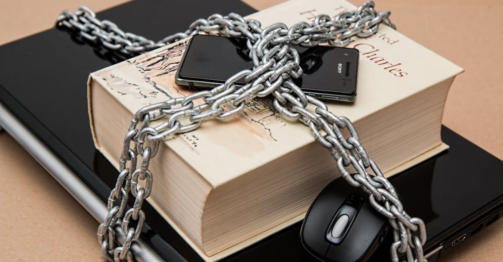 Safety - Chain-locked book, phone, and laptop symbolizing digital and intellectual security.