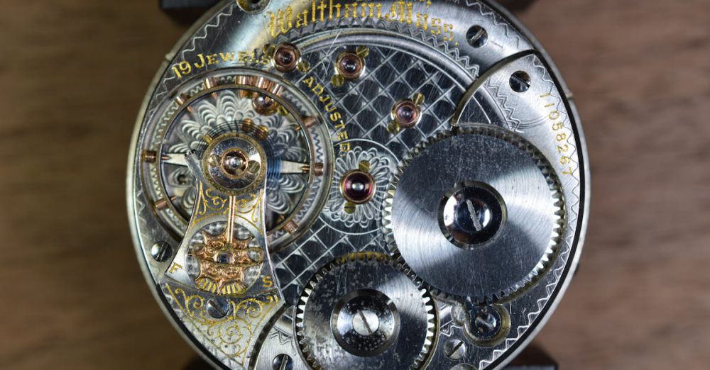 Gear - Close-up of an antique clock mechanism showcasing gears and intricate details.