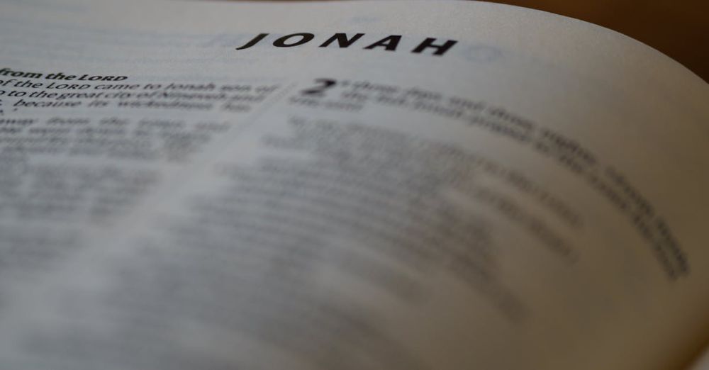 Fish Types - A close focus view of the Book of Jonah text from the Bible with a blurred background.