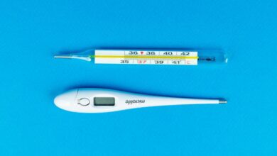 Thermometers - Digital and mercury thermometers on blue background for medical concept.