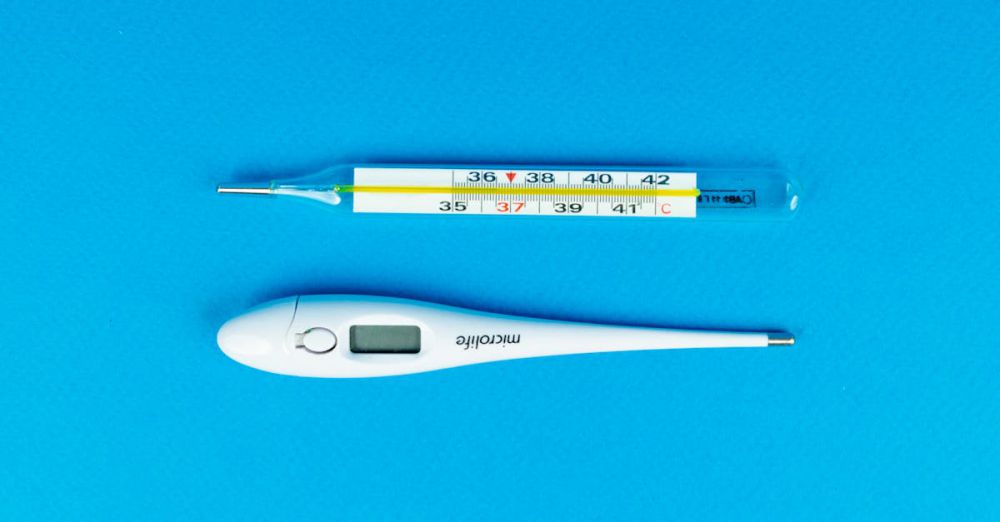 Thermometers - Digital and mercury thermometers on blue background for medical concept.