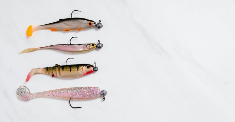 Trout Fishing - Four fishing lures lined up on a white background in a studio setting.