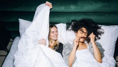 Best Time - Two young women enjoying a fun sleepover, sharing smiles and laughter in a cozy bedroom.