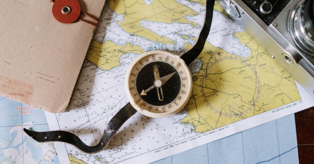 Safari Planning - Compass and camera on a vintage map flat lay, perfect for travel planning and navigation themes.