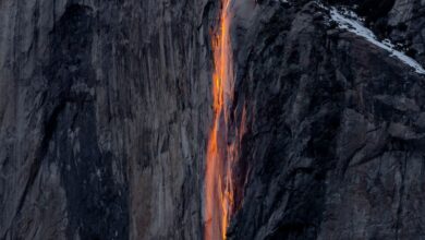 National Parks - Captivating display of Yosemite's Firefall glowing against a snow-covered cliff at sunset.