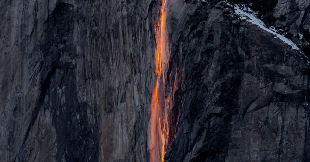 National Parks - Captivating display of Yosemite's Firefall glowing against a snow-covered cliff at sunset.