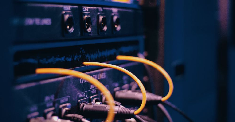 Routers - Close-up of network cables and ports in a server rack, showcasing connectivity.