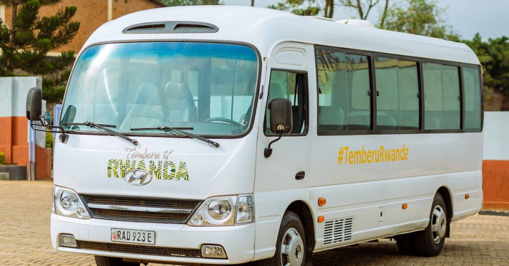 Safari Tours - A white tourist bus with TemberuRwanda branding parked outdoors in Rwanda.