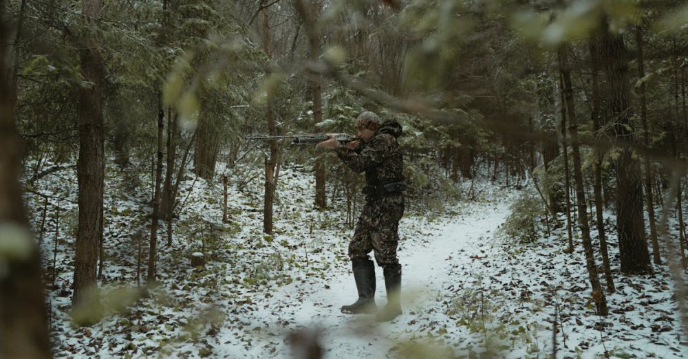 Wildlife Respect - Camouflaged hunter aims rifle on a snowy path in a dense forest during winter.