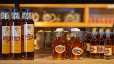Maple Syrup Festivals - Variety of maple syrup and granulated sugar on display in a cozy shop setting.