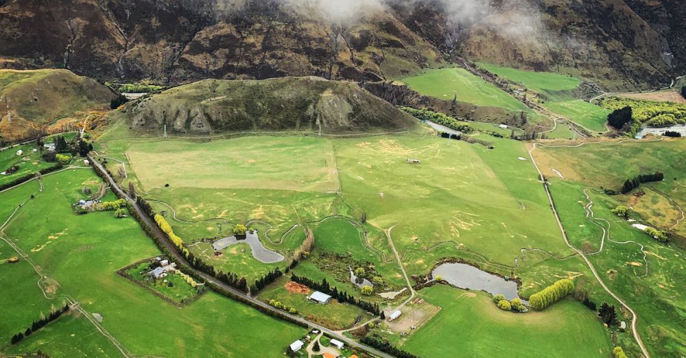 Scenic Farms - Drone shot capturing a serene and scenic rural landscape enveloped in mist and greenery, evoking tranquility.