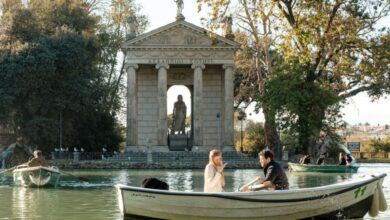 Couple Tours - Couple enjoying a romantic boat ride near the Temple of Asclepius, Rome's picturesque landscape.