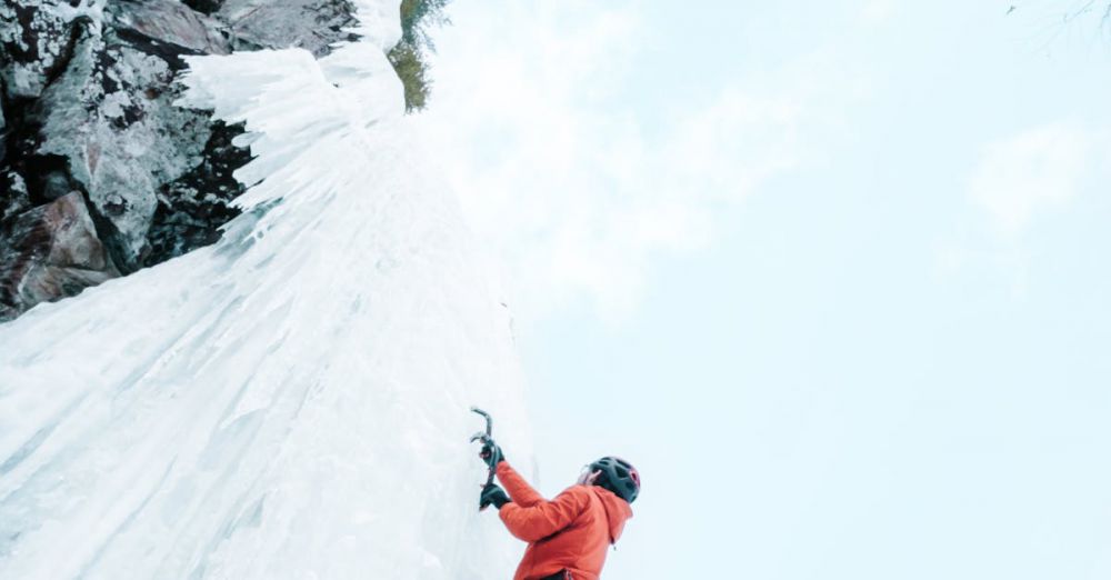 Quebec Experiences - Thrilling ice climbing adventure on frozen walls in Quebec during winter.