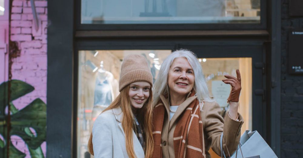 Discounts - Two smiling women with shopping bags outside a trendy store. Embracing city life.