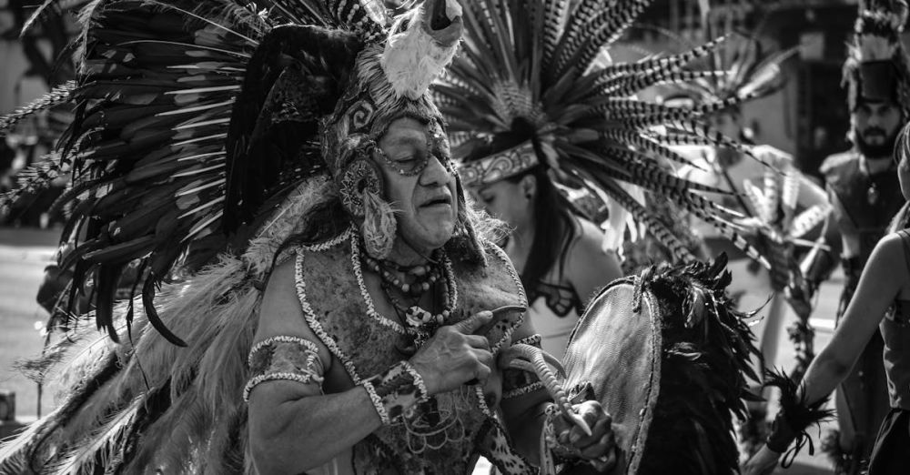 Indigenous Peoples - Black and white photo of performers in traditional indigenous attire during a parade in Mexico City.