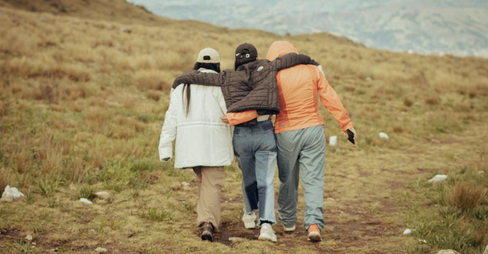 Year-Round Travel - Three friends hiking together in Huaraz, Peru, enjoying the scenic Andes landscape.