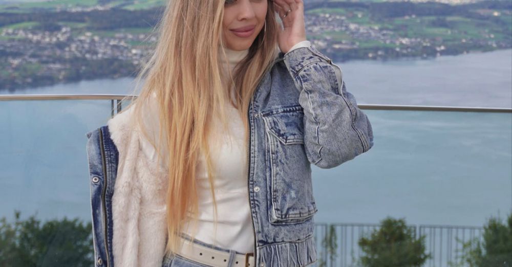 Weekend Trips - Blonde woman in denim outfit posing by a lake with breathtaking view.