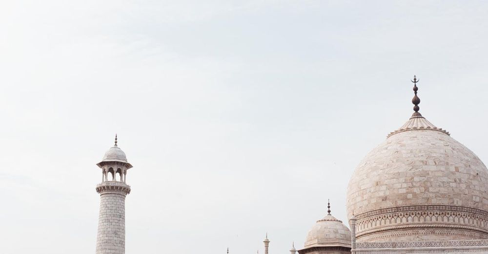 Fascinating Sites - Stunning view of the Taj Mahal's intricate architecture from afar on a clear day.