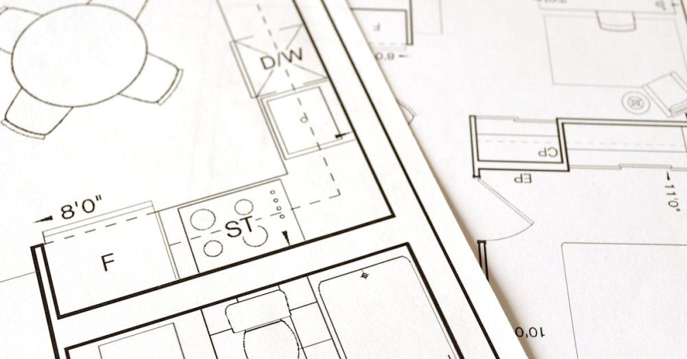 Preparation - Close-up view of an architectural floor plan on paper showcasing detailed room layouts and measurements.