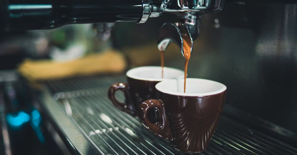 Coffee Maker - Close-up of a professional espresso machine brewing coffee into cups.