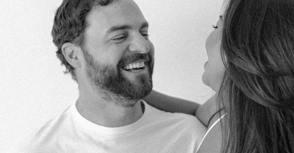 Couples Spas - A joyful couple captured in a black and white studio portrait, highlighting love and connection.