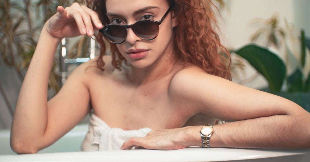 Spa Day - Woman in sunglasses relaxing in a bathtub surrounded by indoor plants in São Paulo.