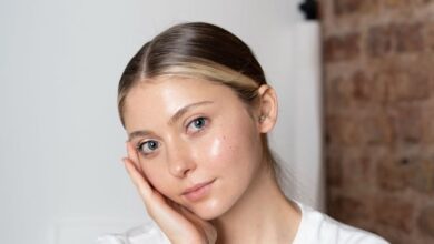 Skincare Spas - Portrait of a young woman with a thoughtful pose in a minimalist setting.