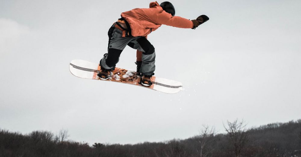 Outdoor Adventures - Capture the excitement of snowboarding with this action-packed leap from a snowy ramp.