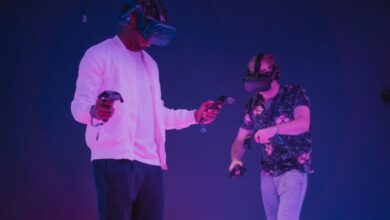 Advanced Players - Two men wearing VR headsets and controllers immersed in a virtual reality gaming environment.