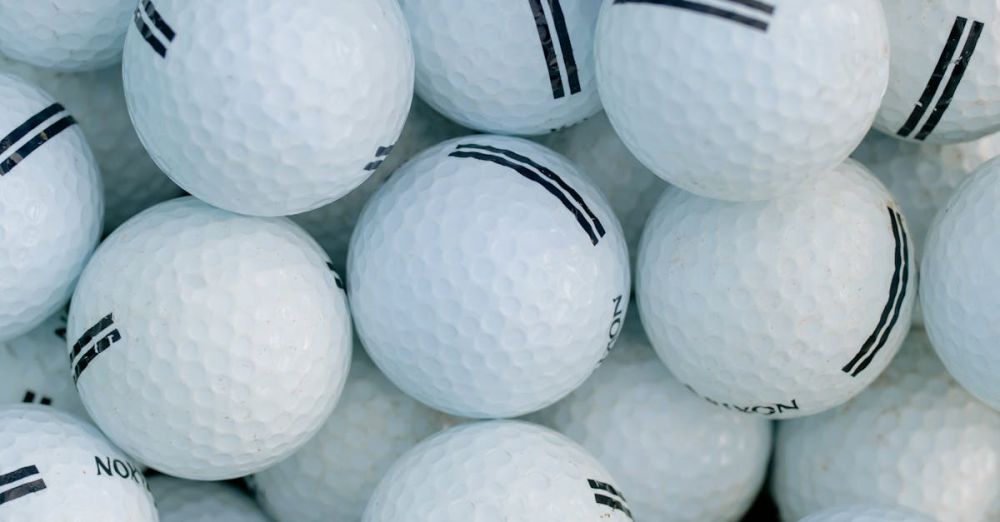 Year-Round Golf - A detailed close-up shot of a pile of golf balls, perfect for sports themes. Ideal for golf enthusiasts.