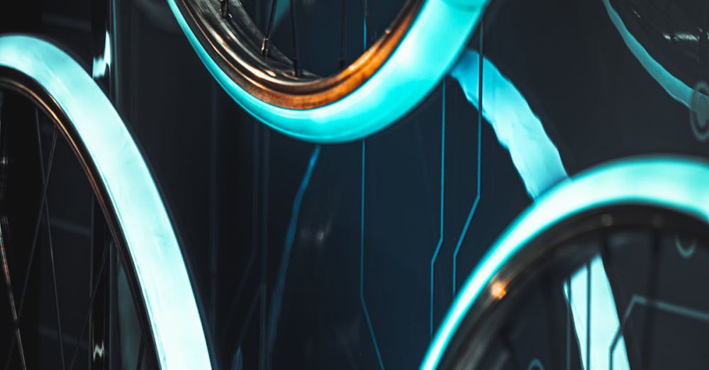 Year-Round Cycling - Close-up of glowing bicycle wheels with a futuristic dark background, perfect for modern design themes.