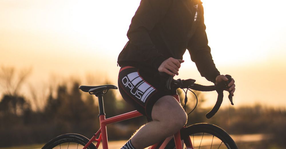 Ontario Cycling - A cyclist riding a red bicycle during sunset in Ottawa, wearing a helmet and black jacket.