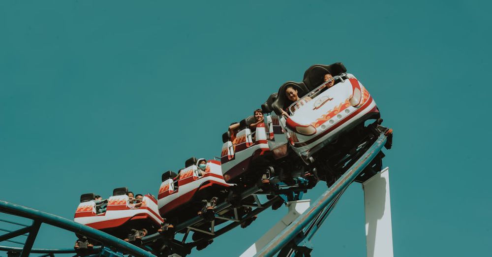 Group Rides - A group of people enjoying a thrilling roller coaster ride at an amusement park.