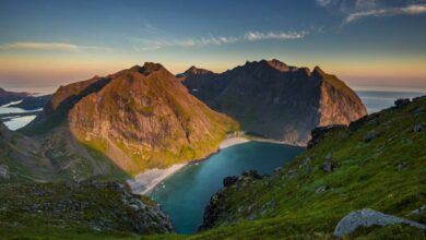 Adventure Experiences - Scenic view of Lofoten Islands landscape at sunset with mountains and fjord.