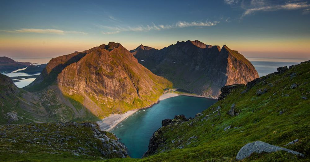 Adventure Experiences - Scenic view of Lofoten Islands landscape at sunset with mountains and fjord.