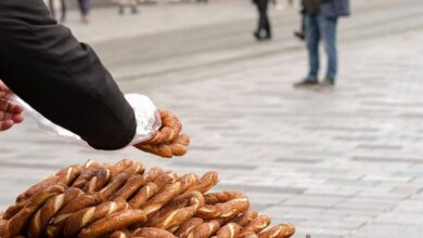 Authentic Experiences - A street vendor sells simit bread at a busy pedestrian street in Istanbul, Turkey.