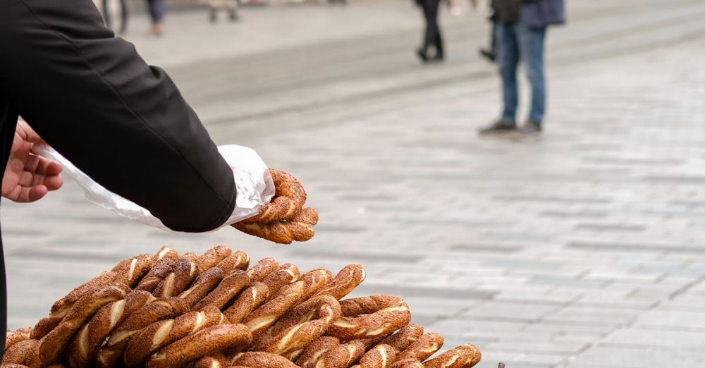 Authentic Experiences - A street vendor sells simit bread at a busy pedestrian street in Istanbul, Turkey.