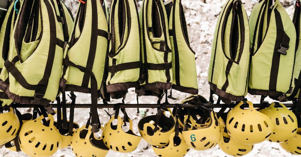 Kayaking Safety - Hanging safety vests and helmets for outdoor adventure activities.