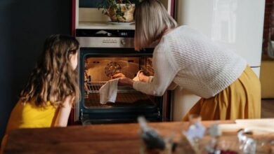 Oven - A mother and daughter baking a cake in a cozy kitchen setting, enhancing family time.