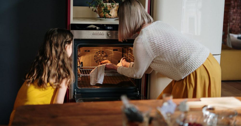 Oven - A mother and daughter baking a cake in a cozy kitchen setting, enhancing family time.