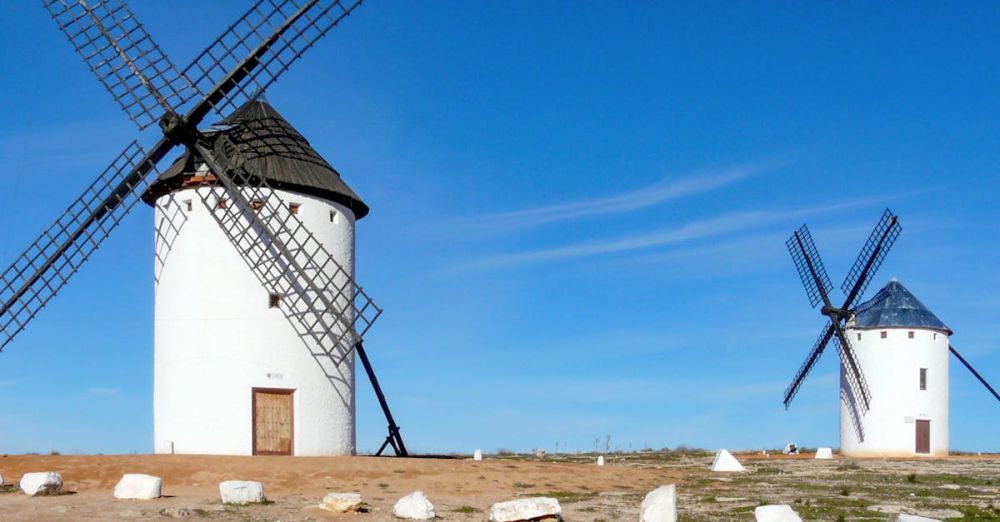 Photography Locations - Traditional windmills under a blue sky in Campo de Criptana, a symbol of Spanish heritage.