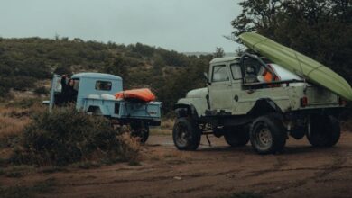 Kayaking Gear - Two 4x4 trucks with kayaks secured, set for a rugged off-road journey.