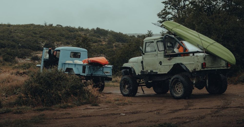 Kayaking Gear - Two 4x4 trucks with kayaks secured, set for a rugged off-road journey.