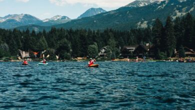 National Parks Kayaking - Kayakers enjoy a scenic adventure on a pristine lake with mountain views in Whistler, BC.