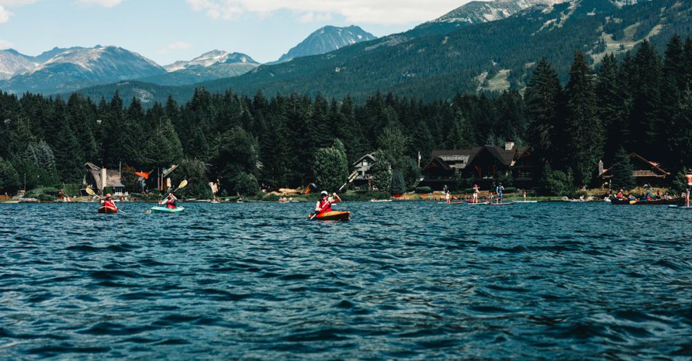 National Parks Kayaking - Kayakers enjoy a scenic adventure on a pristine lake with mountain views in Whistler, BC.