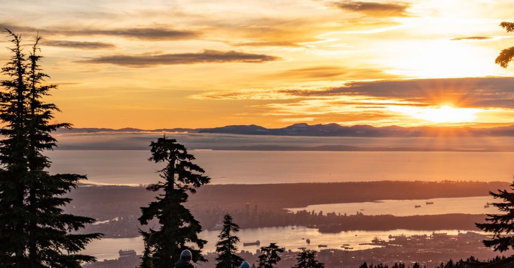 Snowshoeing Trails - Scenic winter sunrise with people on snow-covered mountains in BC, Canada.