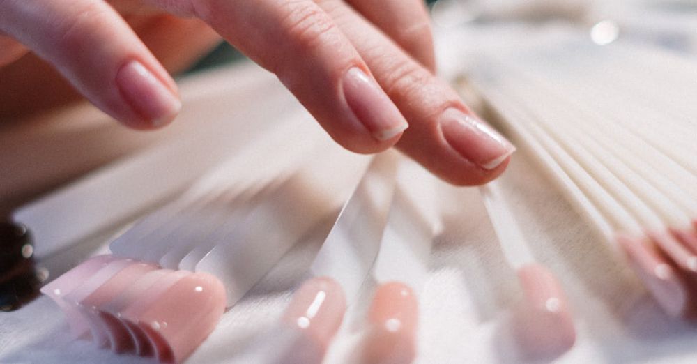 Choosing Snowshoes - Close-up of a woman's hand selecting nail polish colors in a beauty salon.