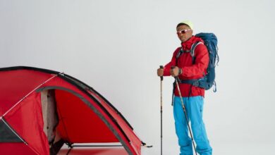 Snowshoeing Gear - Young man ready for a winter camping adventure with a tent and hiking gear.