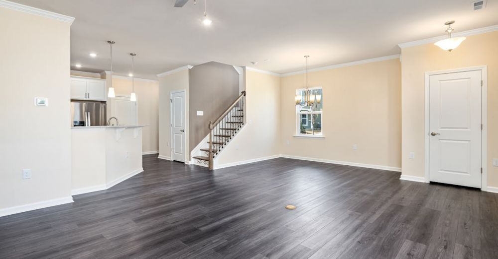 Refurbished Appliances - Empty modern living space with hardwood flooring and ceiling fan, ideal for new home or renovation concepts.