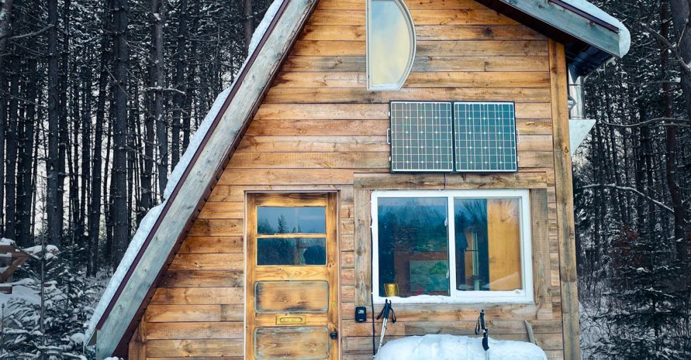 Solo Snowshoeing - A picturesque wooden cabin amid snow-covered trees in Québec, Canada capturing winter's tranquility.